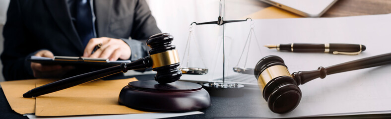 Business and lawyers discussing contract papers with brass scale on desk in office. Law, legal services, advice, justice and law concept picture with film grain effect