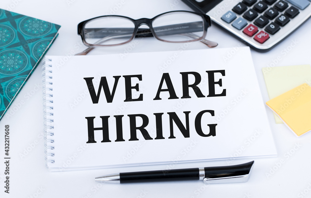 Poster text on notepad with text we are hiring. concept of new job hiring recruitment process, screening of