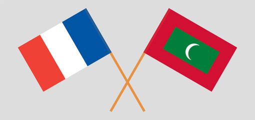 Crossed flags of France and Maldives. Official colors. Correct proportion