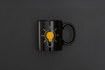 Black mug on black leather background. Inspiration and creative idea concept.  Top view with copy space. Flat lay composition.