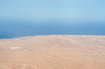 view from the plane window of the Red Sea and the desert in Egypt