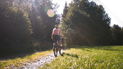 Two girls on mtb bikes. Mother and daughter riding on a forest trail.