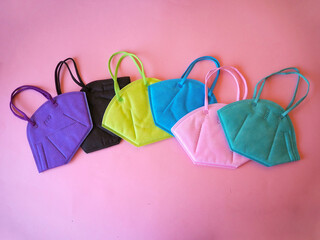 Colorful ffp2 masks on pink background