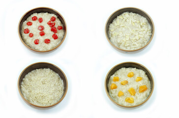 Bowls of oatmeal with cherries dried apricots, pumpkin seeds and sesame seeds