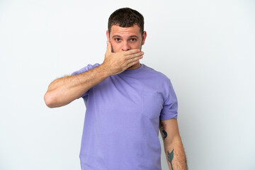 Young Brazilian man isolated on white background covering mouth with hand