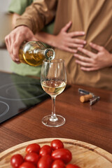 Selective focus on man pouring wine into glass