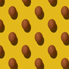 Brown eggs pattern on yellow background, Hard shadows