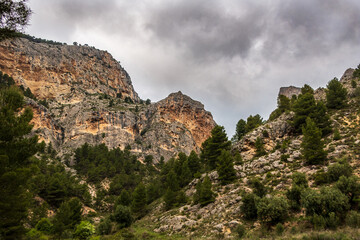 Fototapeta na wymiar Mountains landscape with picturesque rocky walls, in Barranc del Cinc, in Alcoy, Alicante 