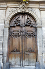 Old ornate door in Paris - typical old apartment buildiing.