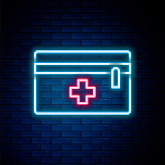 Glowing neon line First aid kit icon isolated on brick wall background. Medical box with cross. Medical equipment for emergency. Healthcare concept. Colorful outline concept. Vector