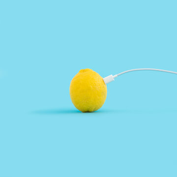 Creative food concept with lemon and usb cable on pastel blue background