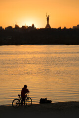 The biker watching the sunset over Kyiv