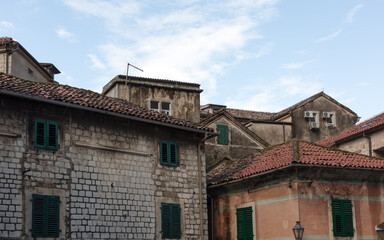 Fototapeta na wymiar Windows, roofs, sky. Old Kotor, Montenego