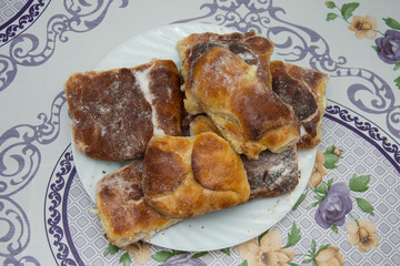 Breakfast,romanian homemade crullers, branzoici on a black tray