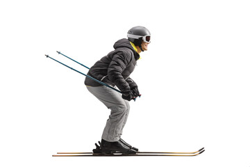 Full length profile shot of a man skiing