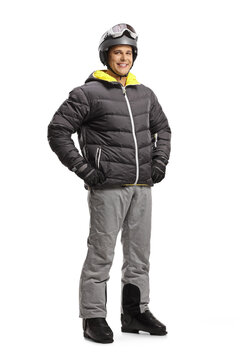 Full length portrait of a young man in a skiing jacket and boots