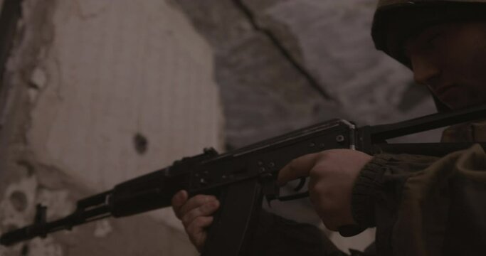 The terrorist shoots from the AK-47 automatic machine. Concept: terrorist attack, study, army.