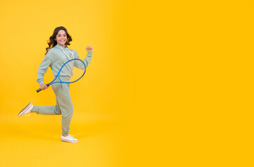Fototapeta na wymiar happy energetic teen girl jump with badminton racquet running to success, copy space, full of energy