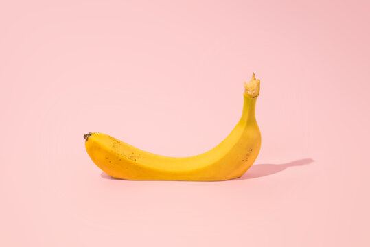 Cutted Banana On A Pink Background. MInimal creativ summer concept.