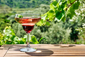 Fresh summer strawberry cocktail or mocktail on the table in garden.Creative drink beverage on sunlight with shadows