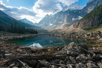 Partly sunny day with dramatic sky over Consolation Lakes in Banff National Park, Canada. Spectacular landscape of Canadian Rockies in summer. Canadian lakes and woods between tall peaks.