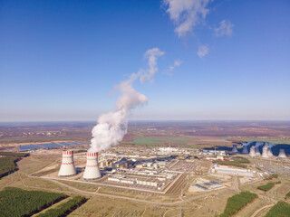 Nuclear Power Station with two smoking cooling towers. Aerial view