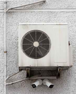 Air conditioner on wall. Cameras monitoring the area around the building