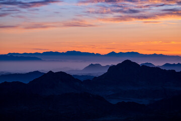 Early morning in ancient mountains of Sinai desert. Sunrise over Red sea