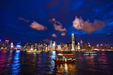 Fototapeta na wymiar Victoria Harbour Hong Kong night view with junk ship on foreground