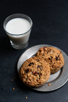 Cookies on plate with milk
