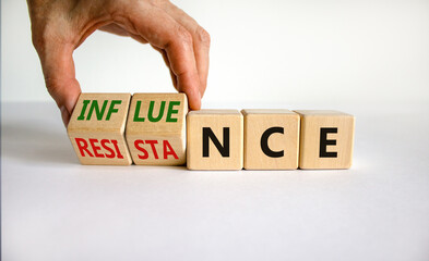 Influence or resistance symbol. Businessman turns cubes, changes the word 'resistance' to...