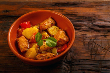 Food for suhoor in ramadan on a wooden table braised laran meat with potatoes. Copy space