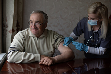 Fototapeta premium Happy senior man being vaccinated