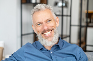 Headshot of handsome charismatic mature man in casual shirt. Close Up portrait of bearded...