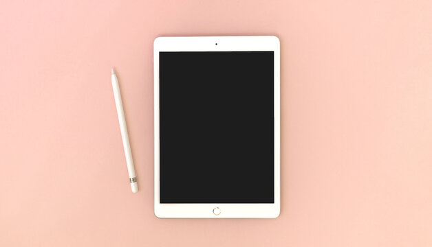 Kharkov, Ukraine - May 5, 2021: Digital Tablet Apple IPad With Pencil On Bright Peach Background, Mockup Or Template Photo