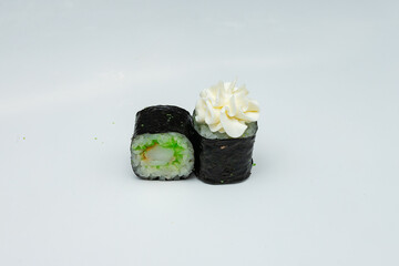 a portion of two sushi rolls with hot sauce is on the table on a white background, a prepared Asian dish of seafood and fresh rice, delicious food
