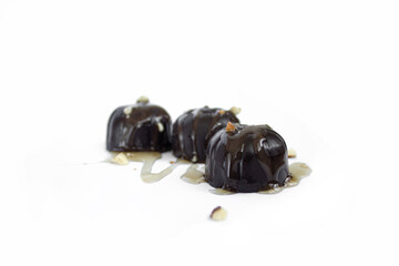 chocolate candies with melted chocolate macro isolated on a white background