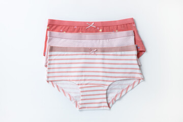Set of multicolored cotton baby panties, underwear for girls on white background. Top view, copy space, flat lay, close-up. Children's clothing concept, wardrobe organization. Horizontal