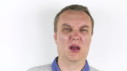 Fresh herring hits a young man's face. Funny man gets slapped in the face with wet fresh fish. - Powered by Adobe