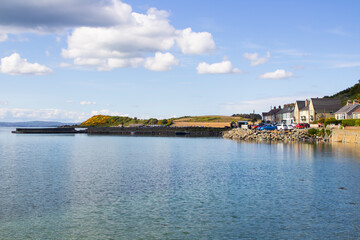 Fototapeta na wymiar The small harbour at Kircubbin on Strangford Lough in County Down Northern Ireland. The viillage is located on the western side of the Ards Peninsula. The harbour contains leisure craft and yachts, 