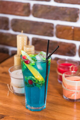 Cold citrus lemonade in a glass on a wooden table