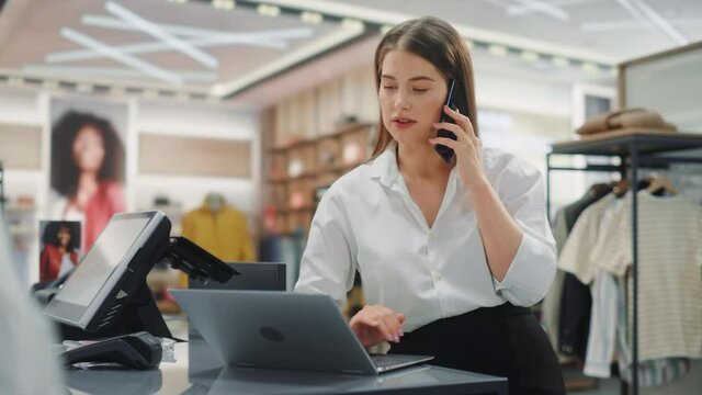 Modern Clothing Store: Friendly Customer Support Specialist Talks to Client on the Smartphone. Smiling Retail Sales Manager or Young Designer Contacts Client about Online Order in Fashion Shop