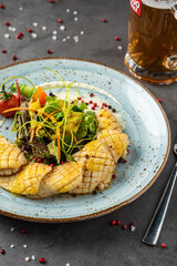 BBQ grilled squid calamary and ingredients on dark background with salad.