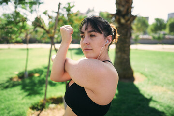 a beautiful white woman with brown hair exercises her arms to be ready for physical activity                  