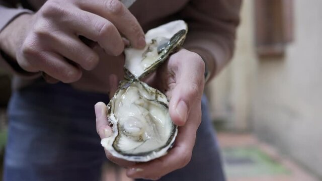 Opening oyster close-up with knife