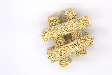 Crispy rice rollers stacked like a hash mark on white background