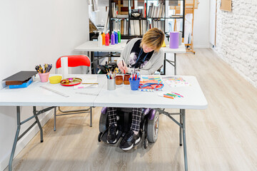 disabled woman in a wheelchair learning to paint