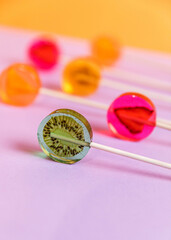Sugar-free lollipops with dry fruits inside on a lilac background. Healthy sweetness, benefits of natural fruits