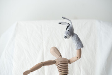 artist's mannikin or manikin posing with donkey or mule finger puppet - arms stretched up