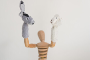artist's mannikin or manikin posing with mule or donkey and sheep finger puppets - arms up